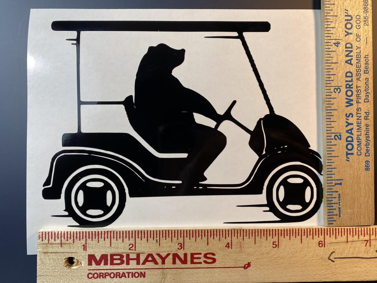 Black vinyl silhouette of a bear driving a golf cart