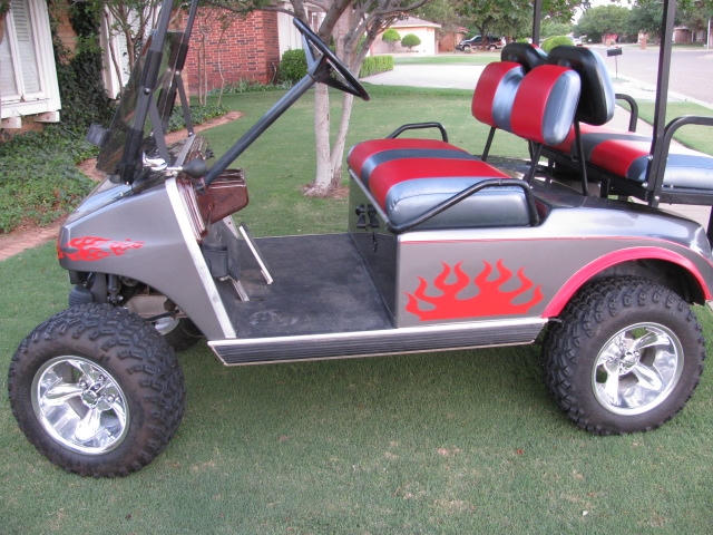 Golf cart with red flame vinyl graphics on the side